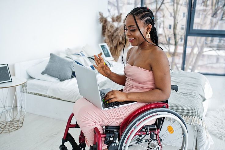 Customer using a laptop while seated in a wheelchair