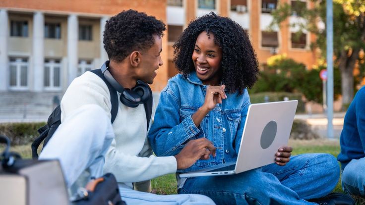 Students using a laptop outdoors