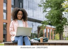 Student studying outdoors using a laptop